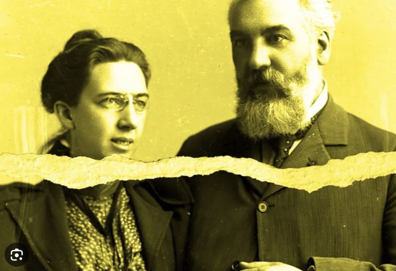 black & white photo with yellow tint. the photo appears torn apart vertically. Alexander Graham Bell and his deaf wife, Mabel. left: woman with glasses and hair bun wearing a blouse and jacket. right: male with white beard and mustache in a suit jacket.