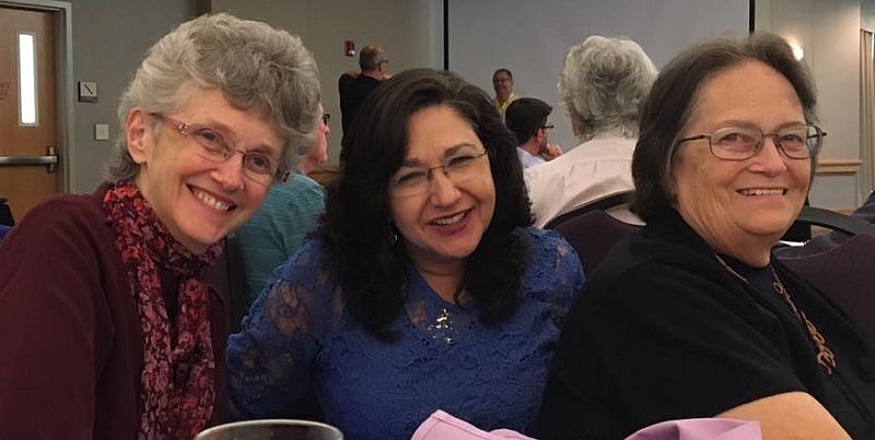 three women: Bishop Peggy Johnson, Michelle Menefee, and Carol Stevens, sitting together