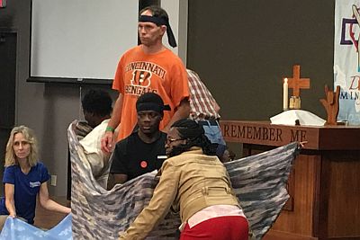 group on stage, in a makeshift boat