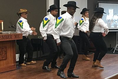 six dancers in white shirts