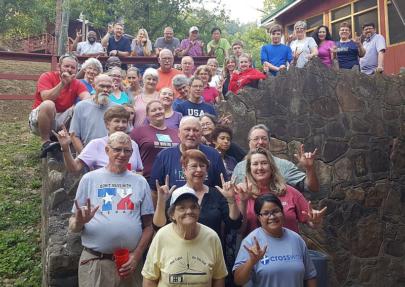 entire group poses on a hillside