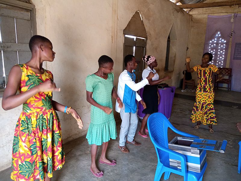 several of the group dance and sing.